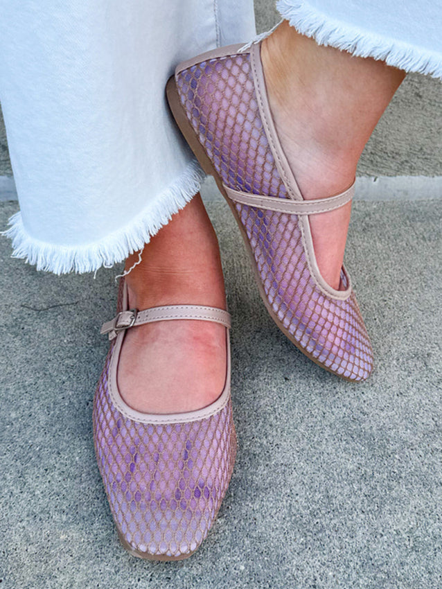 A pair of chic mesh Mary Jane ballet flats with a closed almond toe and buckle strap.