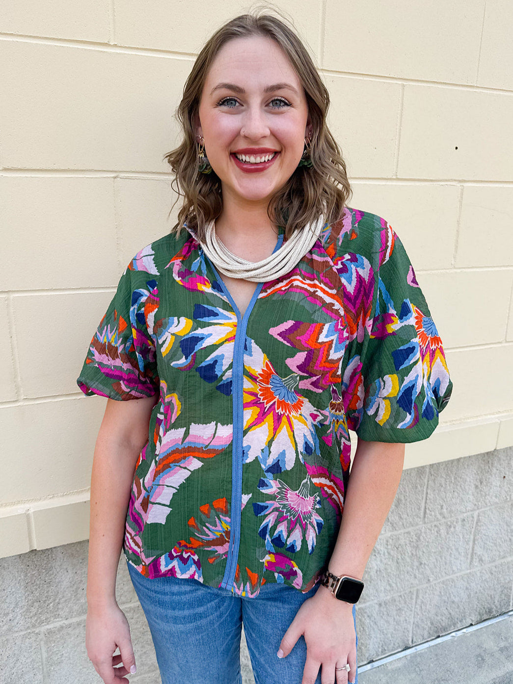Puff sleeve printed top with teal base and colorful abstract floral pattern
