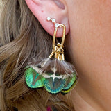 Mallard-colored feather tassel statement earrings with earthy greens and browns, displayed on a neutral background