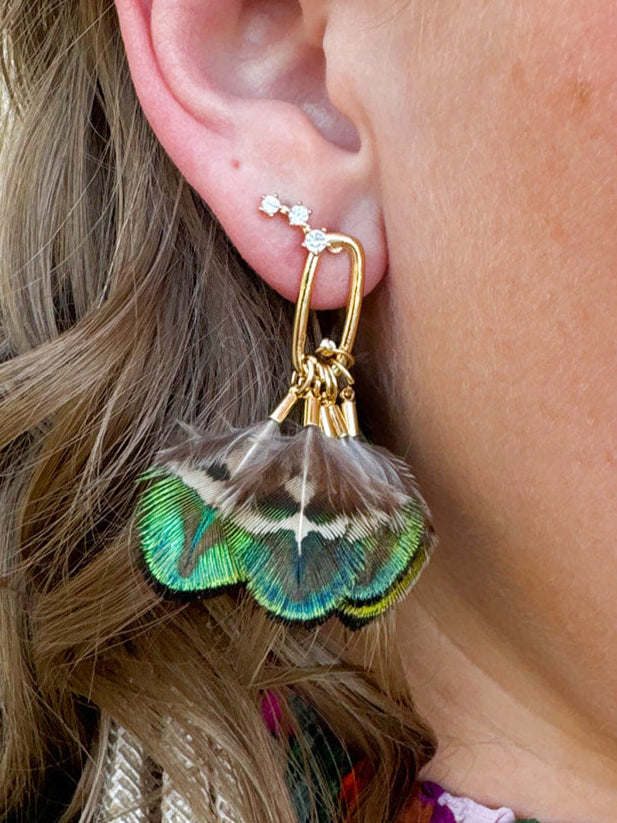 Mallard-colored feather tassel statement earrings with earthy greens and browns, displayed on a neutral background