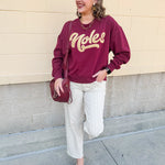 Garnet crewneck sweatshirt with dropped shoulders and gold chenille “Noles” script lettering.