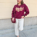 Garnet crewneck sweatshirt with dropped shoulders and gold chenille “Noles” script lettering.
