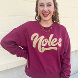 Garnet crewneck sweatshirt with dropped shoulders and gold chenille “Noles” script lettering.
