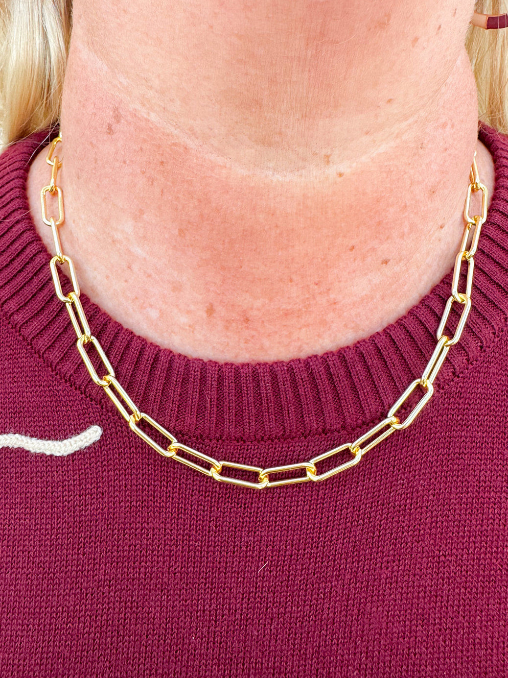 Bright gold chunky paperclip necklace with bold links and collarbone-grazing length