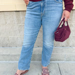 Medium-wash straight-leg jeans with midrise fit and light distressing, designed for comfort and style.