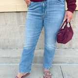 Medium-wash straight-leg jeans with midrise fit and light distressing, designed for comfort and style.