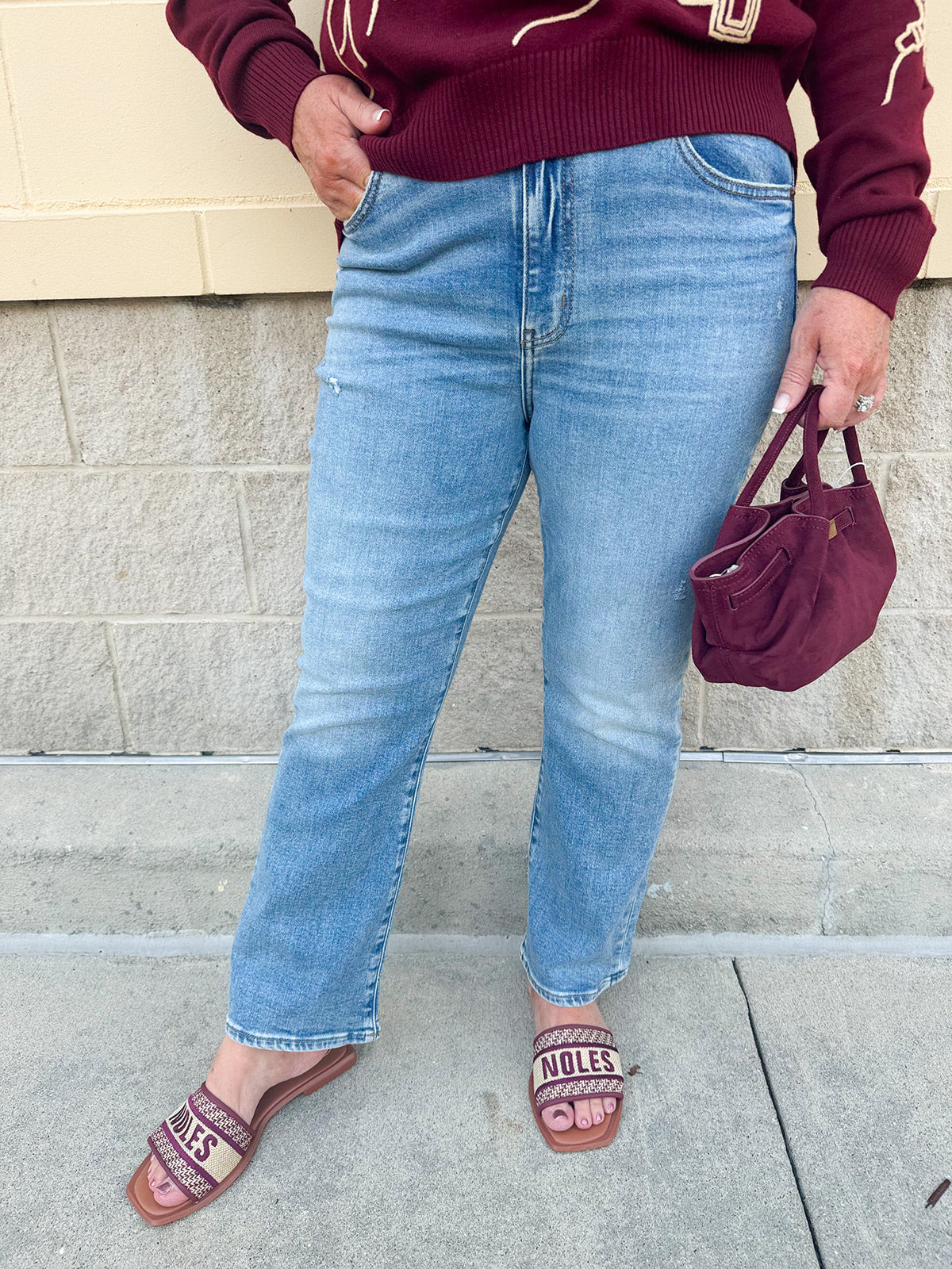 Medium-wash straight-leg jeans with midrise fit and light distressing, designed for comfort and style.