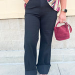 Black high-rise wide-leg jeans with cuffed hems