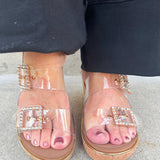  Clear rhinestone buckle wedge sandals with a neutral sole, offering stylish sparkle and all-day comfort.