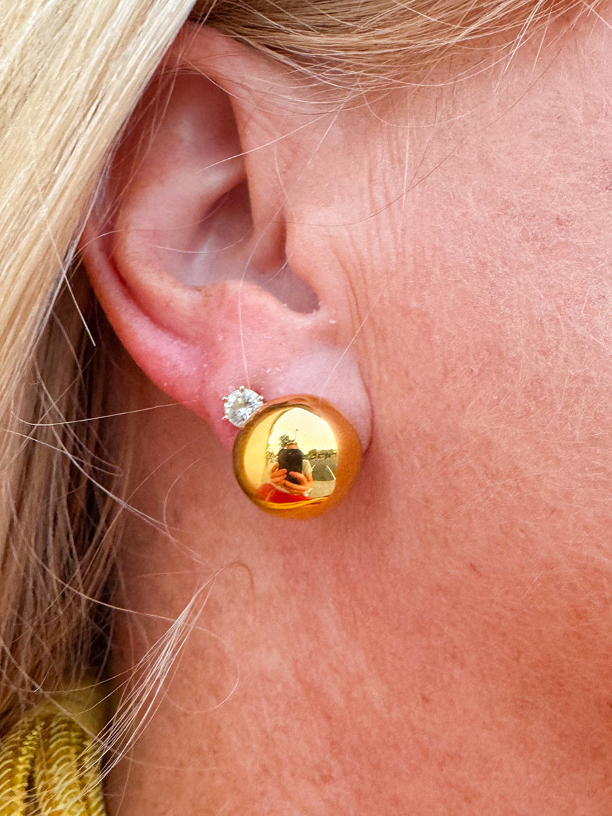 Gold button stud earrings with a mirror-like finish.