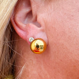 Gold button stud earrings with a mirror-like finish.