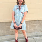 Light wash denim-style dress with cuff sleeves, V-neckline, raw hem, and embroidered garnet “Noles” script on pocket.
