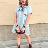 Light wash denim-style dress with cuff sleeves, V-neckline, raw hem, and embroidered garnet “Noles” script on pocket.