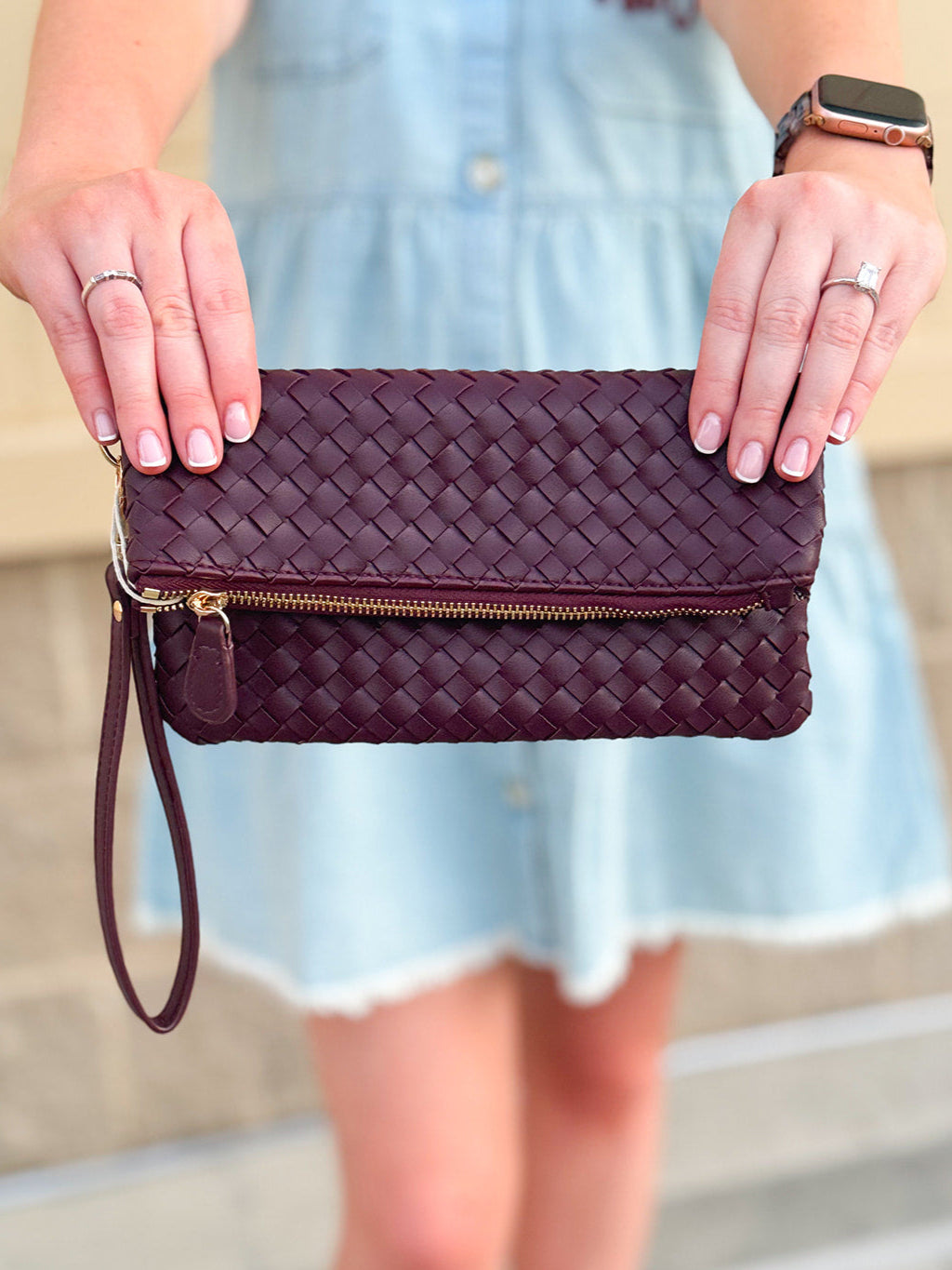 Merlot clutch with gold hardware and wrist strap