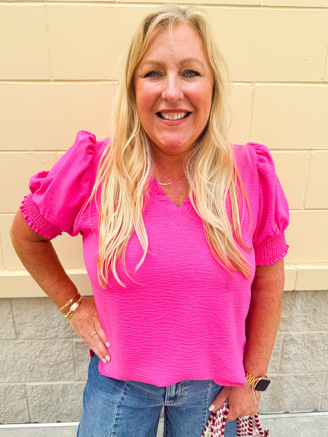 Hot pink top with ruffled neckline and puff sleeves with elastic armbands