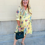 Butter yellow mini shirt dress with button-down front, collar, ¾ sleeves, and striped piping details.