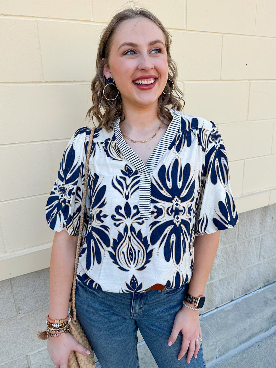Cream blouse with navy and tan design and striped navy and cream sleeve and bottom hems