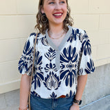 Cream blouse with navy and tan design and striped navy and cream sleeve and bottom hems