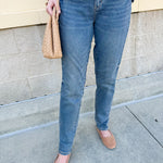 Mid-rise vintage wash boyfriend jeans with relaxed fit, shown cuffed at the ankle.