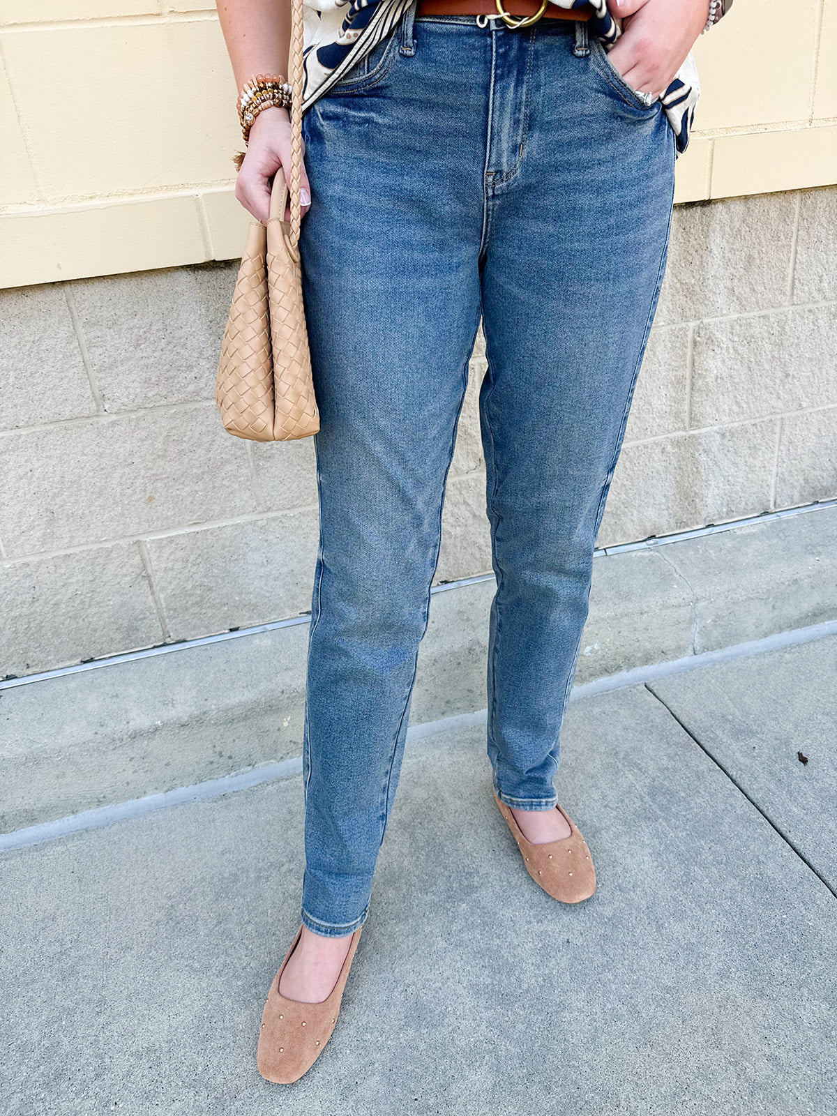 Mid-rise vintage wash boyfriend jeans with relaxed fit, shown cuffed at the ankle.