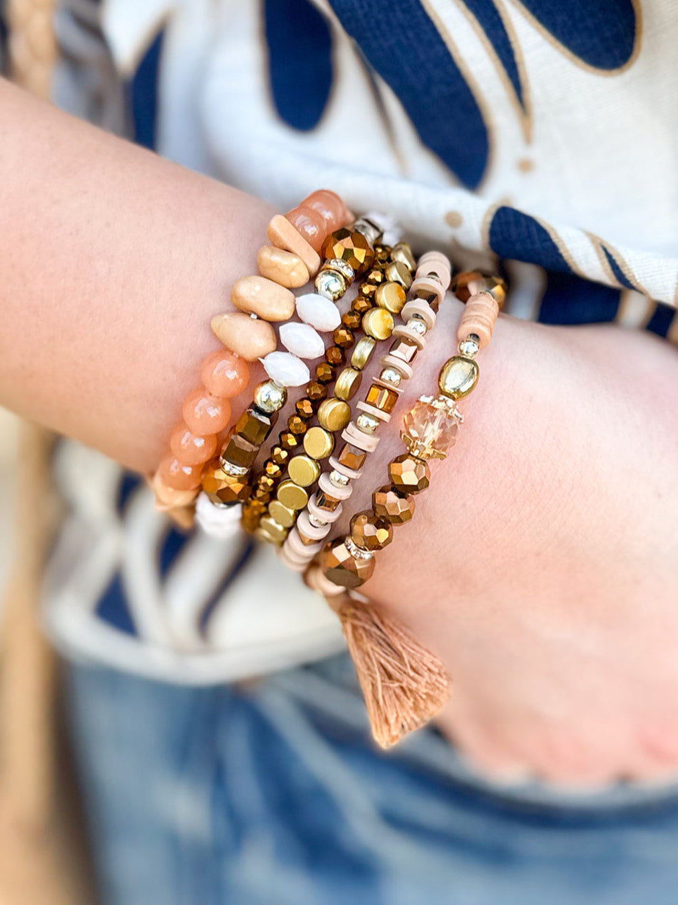 Light brown multi-strand stackable bracelet set featuring mixed beads, crystals, wood, and natural stone with stretch fit.