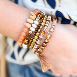 Light brown multi-strand stackable bracelet set featuring mixed beads, crystals, wood, and natural stone with stretch fit.