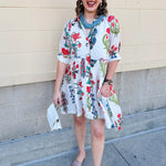 White mini shirt dress with button-down front, collar, ¾ sleeves, and striped piping details.