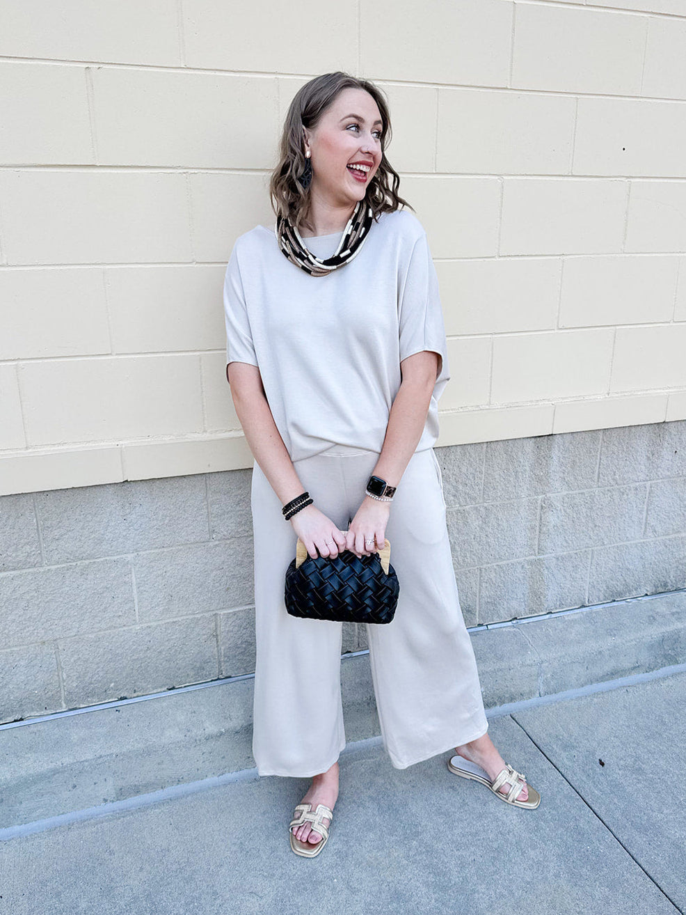 Women’s cream two-piece lounge set with dolman sleeve top and flowy wide-leg pants with pockets