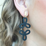 Black and gold drop earrings with two cascading open floral outlines