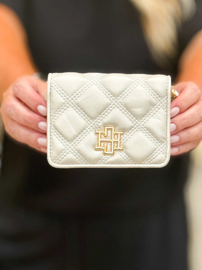 Pearl quilted vegan leather wallet with magnetic closure and zippered back compartment—compact, elegant, and practical.