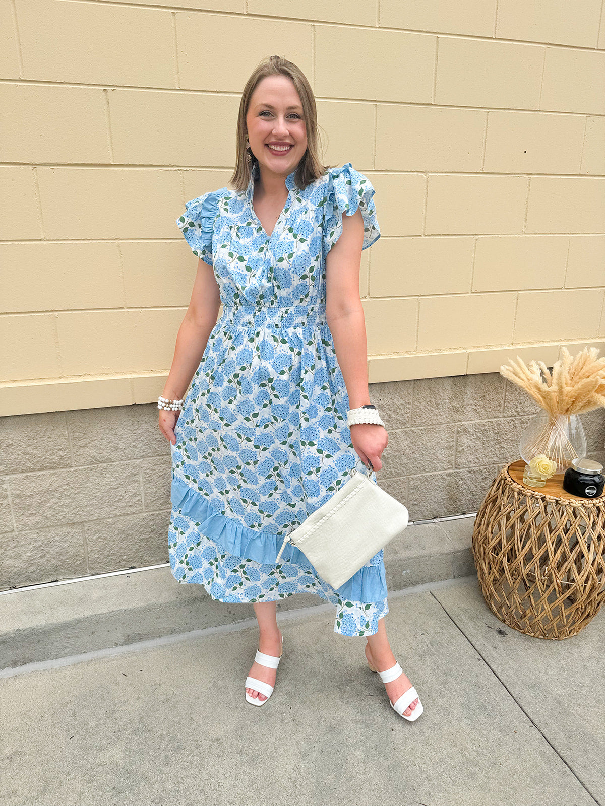Light blue sleeveless dress with ruffle trim and watercolor hydrangea floral print