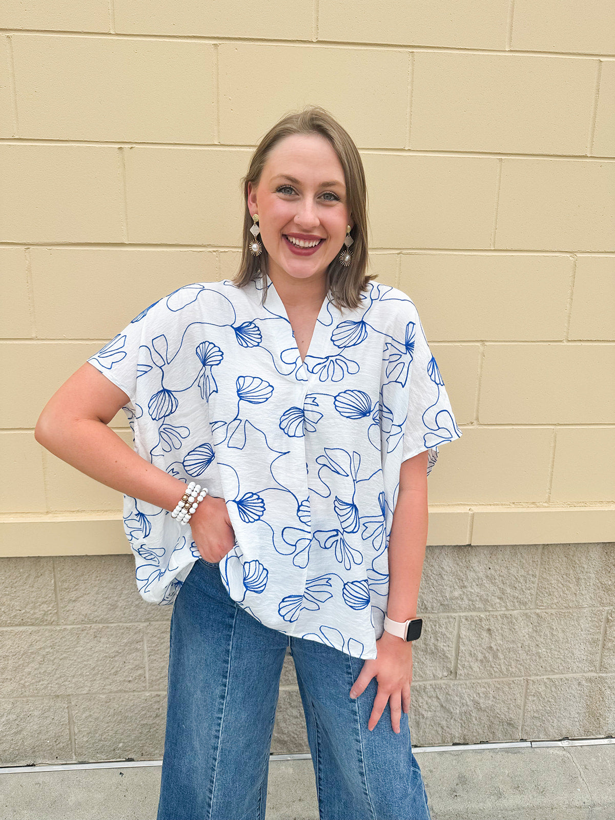 White oversized cotton top with navy seashell embroidery and drop shoulder design