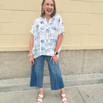 White oversized cotton top with navy seashell embroidery and drop shoulder design