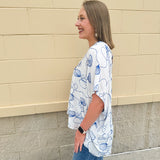 White oversized cotton top with navy seashell embroidery and drop shoulder design