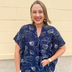 Navy oversized cotton top with cream embroidered seashells and a relaxed silhouette