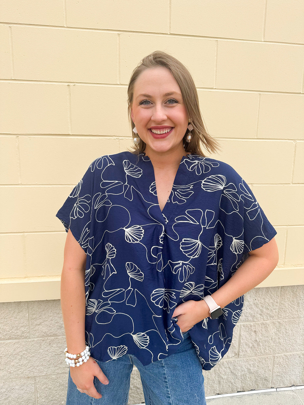 Navy oversized cotton top with cream embroidered seashells and a relaxed silhouette