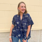 Navy oversized cotton top with cream embroidered seashells and a relaxed silhouette