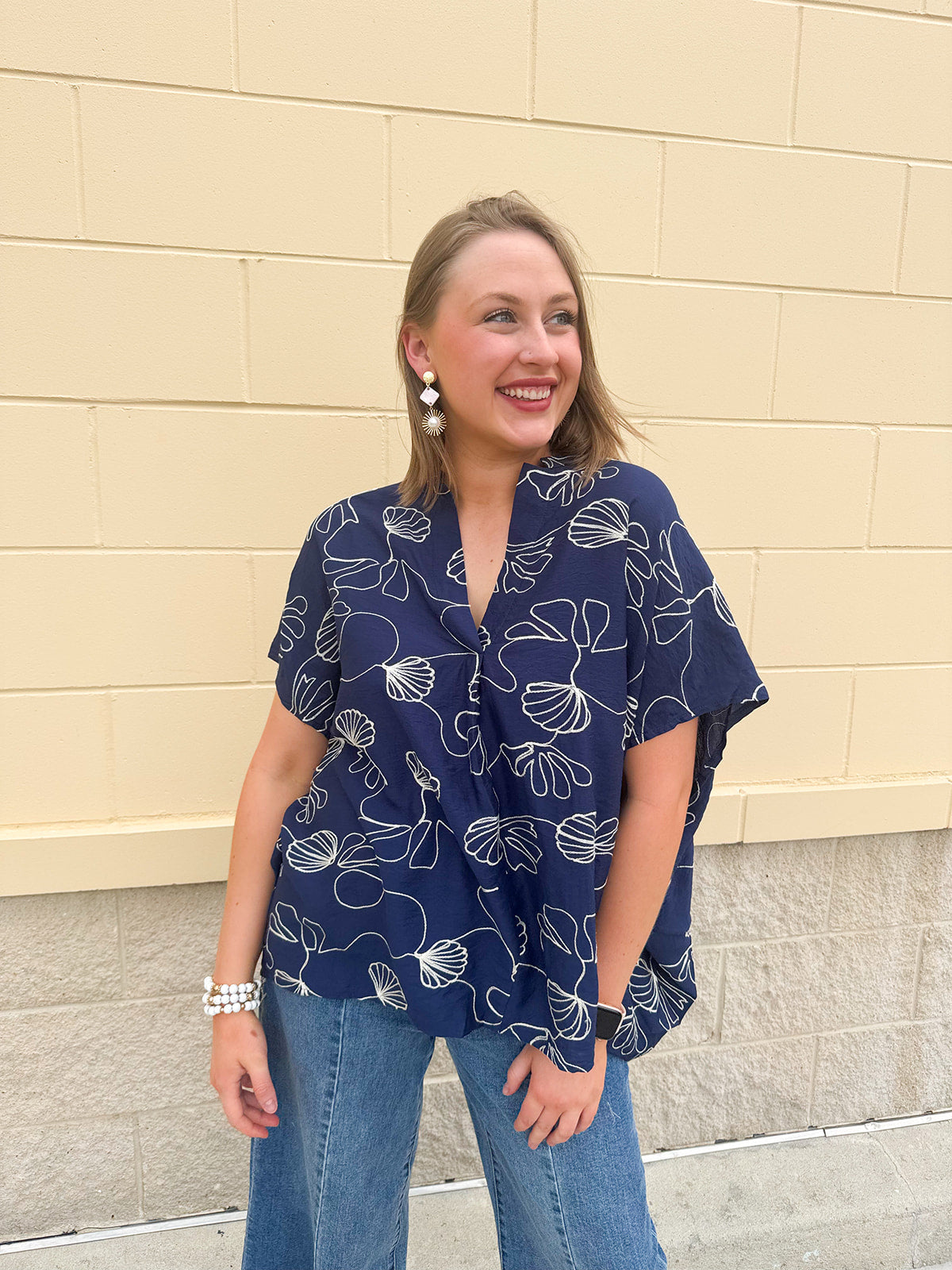 Navy oversized cotton top with cream embroidered seashells and a relaxed silhouette
