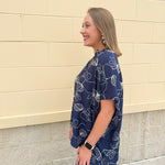 Navy oversized cotton top with cream embroidered seashells and a relaxed silhouette
