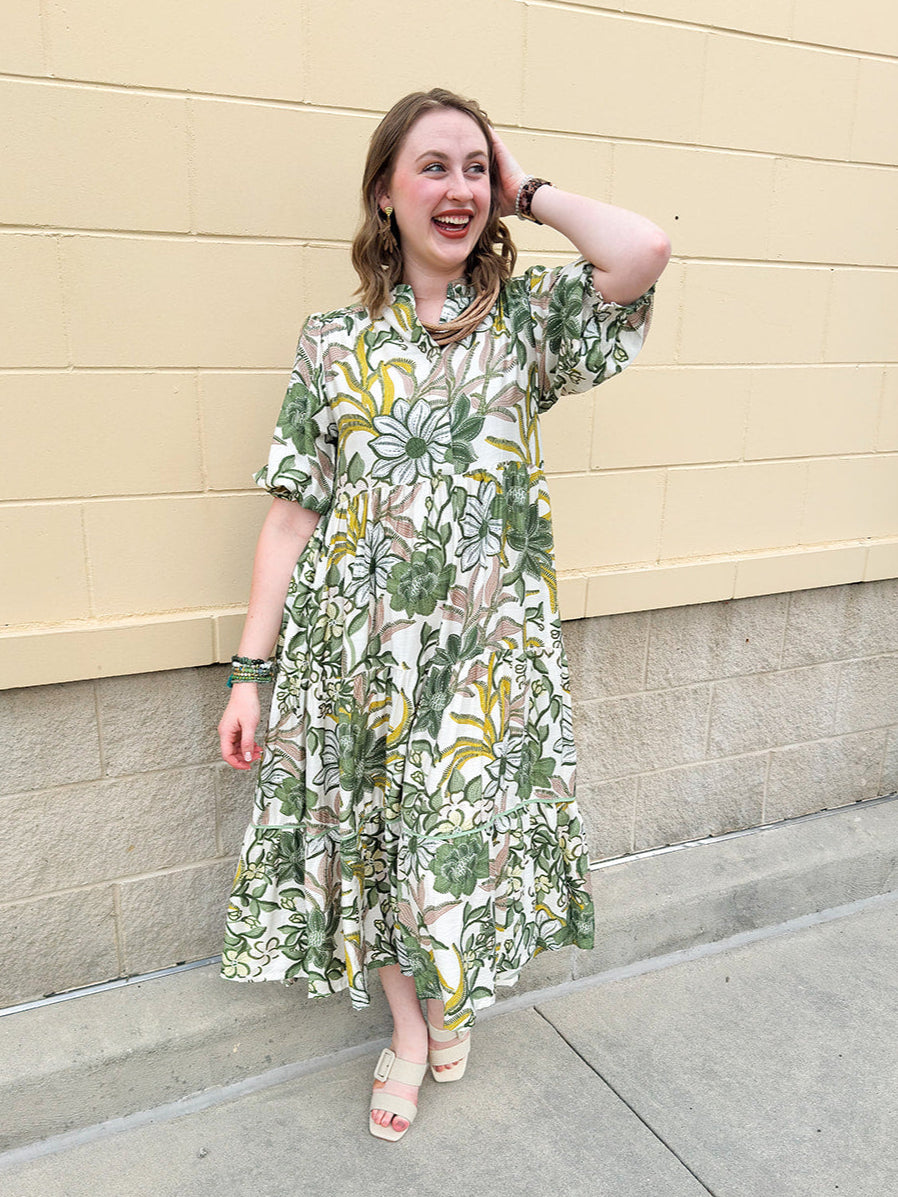 Floral midi dress with green, yellow, pink, and white print and ruffled short sleeves