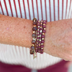Four-stack beaded bracelet set with deep maroon, garnet, and cream beads of varying sizes