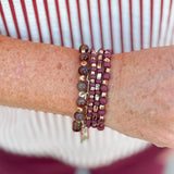 Four-stack beaded bracelet set with deep maroon, garnet, and cream beads of varying sizes