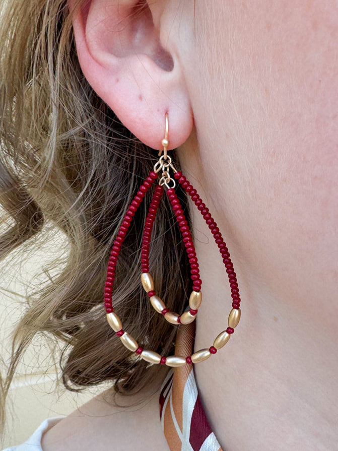 Double teardrop beaded earrings with garnet and gold beads, dangle style for fall, holiday, or gameday wear.