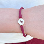 A sleek waterproof silicone bracelet featuring an enamel Florida State University logo charm at the clasp.