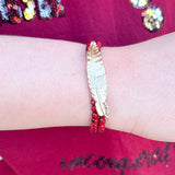 Two-stack bracelet set with garnet glass beads and gold metal feather charm