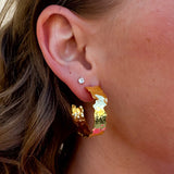 Pair of artisan-style gold-plated hoop earrings with smooth, rounded finish.
