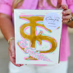 An 8"x10" hand-painted canvas featuring the Florida State FS logo with feather detail in vibrant pink, gold, and blue by Caroline Ree Designs.