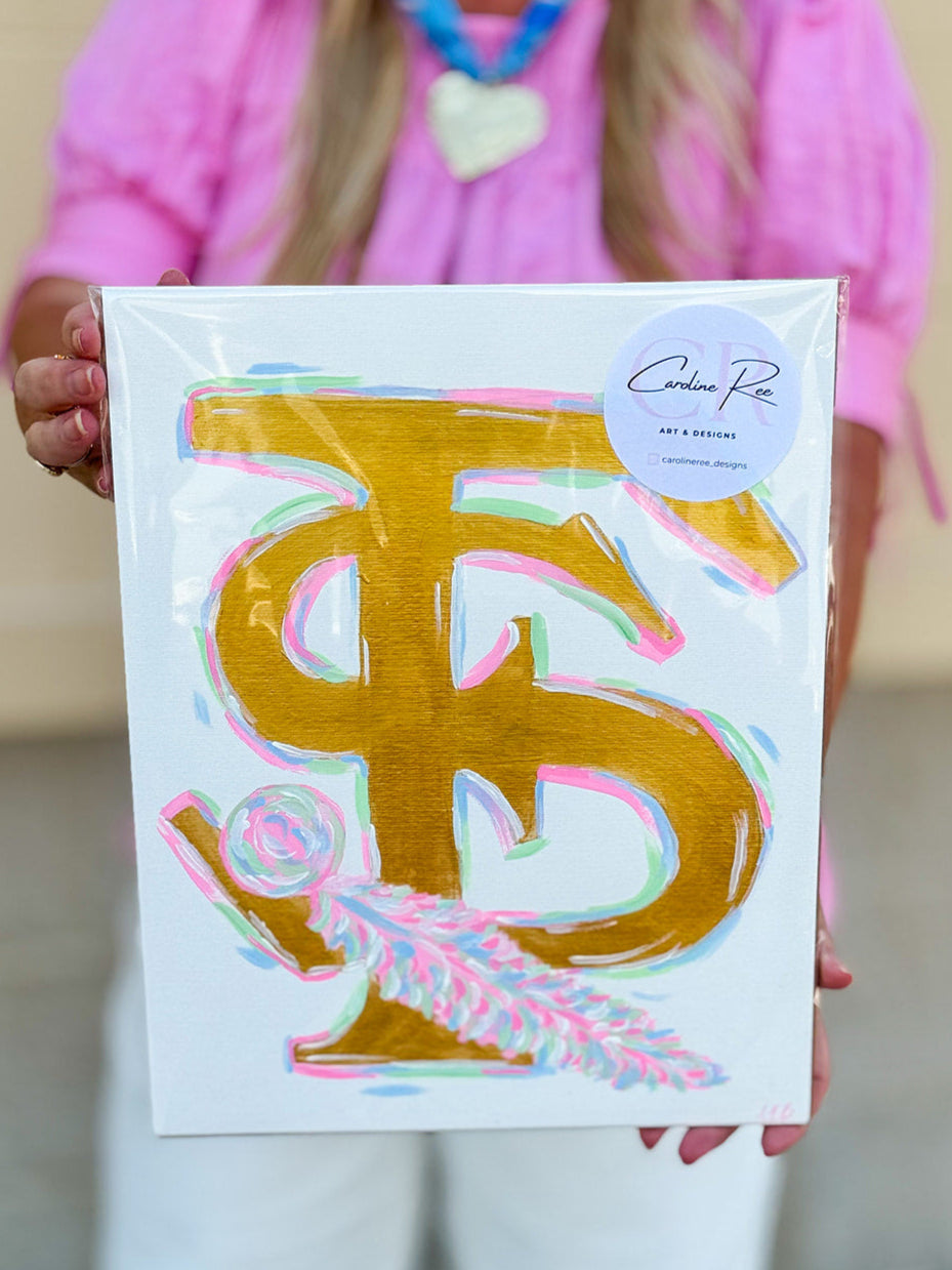 A brightly hand-painted 11"x14" canvas featuring the Florida State FS logo with a stylized feather in pink, gold, and blue tones by Caroline Ree Designs.