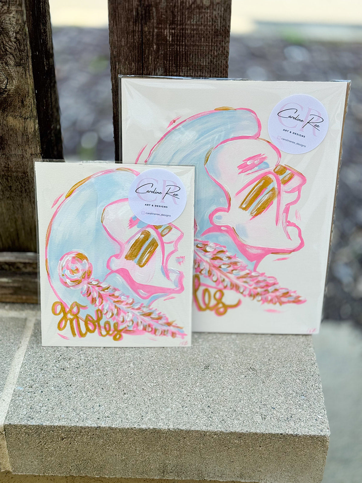 A bold and artistic 11"x14" canvas depicting a hand-painted Seminole design in bright pink, gold, and blue by Caroline Ree Designs.