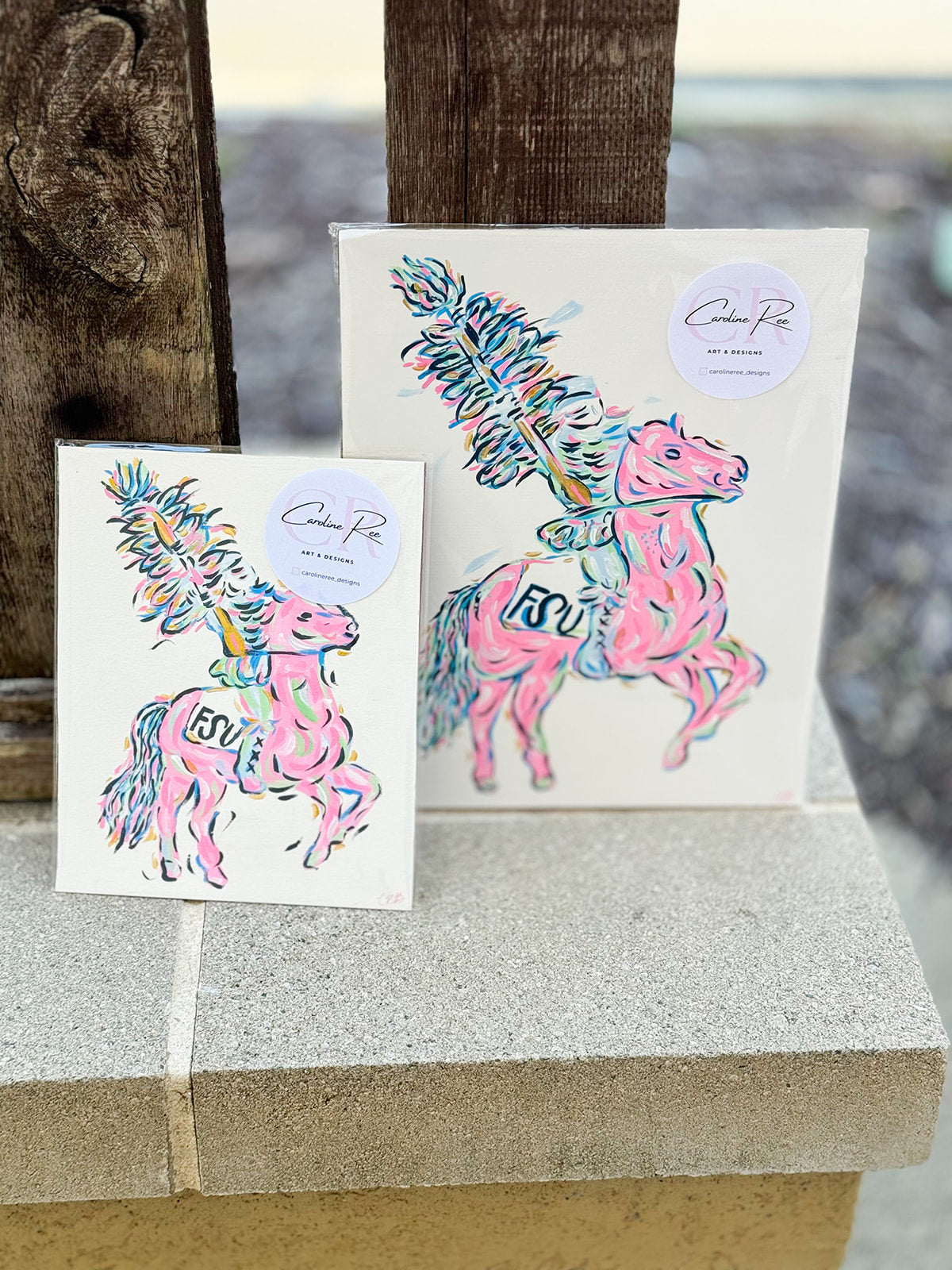 A vibrant hand-painted 8"x10" canvas featuring a stylized Renegade mascot in bright pink, gold, and blue by Caroline Ree Designs.